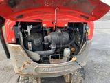 a small engine in the back of a red truck