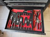 many tools in a tool box on the floor