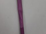 a purple makeup brush on a white surface