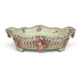 a large bowl with flowers on it on a white surface