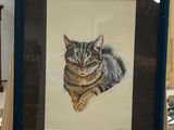 a picture of a cat that is sitting on a easel