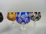three wine glasses sitting next to each other on a table