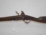 an old gun with a wooden handle and a glass holder