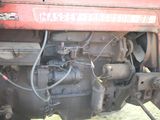 a close up of the engine of a red tractor