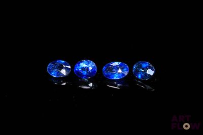 three blue sapphires on a black background