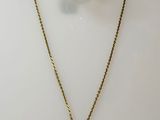 a close up of a necklace and earrings on a white surface