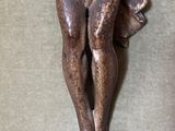 a statue of a man holding a baby on his back