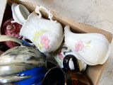 a box full of assorted vases on the floor