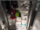 a metal cabinet with a bunch of items inside of it