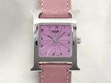 a pink watch with a square face on a pink leather strap