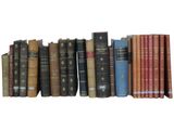 many books that are lined up together on a shelf