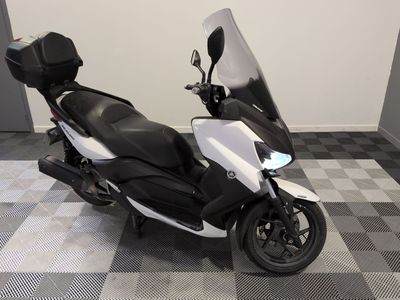 a picture of a motor scooter parked on a checkered floor