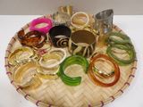 a tray with many different colored bangles on it