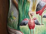 a large vase with a painting of birds on it