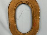 a small wooden letter o on a white surface