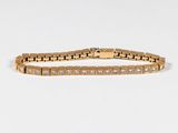 a gold bracelet with diamonds on a white background