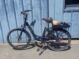 a bike that is parked in front of a blue building