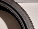 a close up of a tire on a white surface next to a white wall