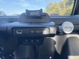a car dashboard with a remote control and a steering wheel