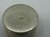 a silver container with a small hole in the middle of it