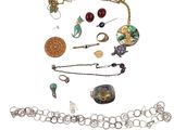 a lot of jewelry that is laying out on the table