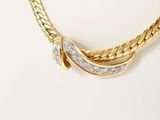 an image of a gold and diamond necklace on a mannequin
