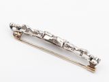 a close up of a silver hair clip on a white surface