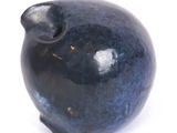 a blue vase that is sitting on a white surface