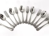 six forks and six spoons arranged in a circle on a white background