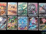 some of the pokemon cards are lined up on a table