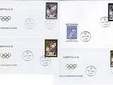 four stamps with olympic symbols on them on a white background