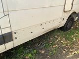 a van that has bullet holes on the side of it