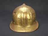 a gold helmet that is sitting on a table