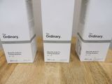 three boxes of the ordinary are sitting on a wooden table
