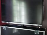 a large flat screen tv sitting on top of a metal case