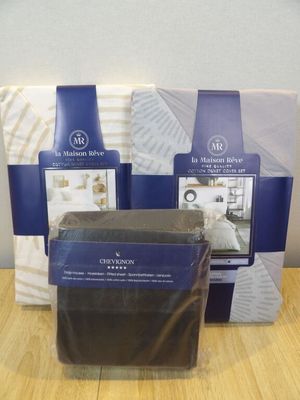 four different types of bedding are displayed on a wooden table