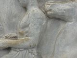 a statue of a man sitting on a horse holding a book