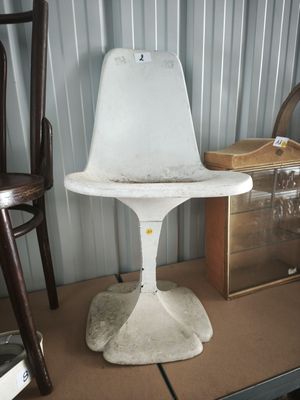 a white chair that is sitting on top of a table