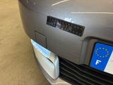 a close up of a car ' s license plate on the front of the car