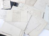 a pile of old papers on a white table