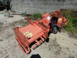 a small orange machine that is sitting in the dirt