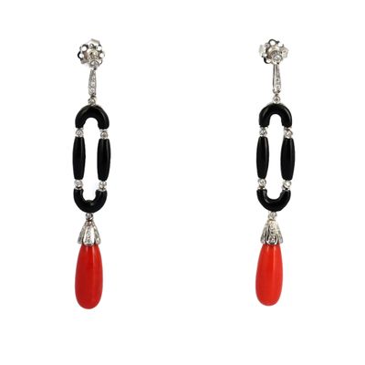 a pair of earrings with black and red beads