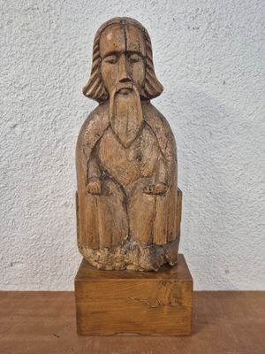 an old wooden statue of a man with a beard and a beard