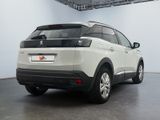 the rear end of a white suv parked in a garage
