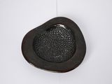 a black bowl that is on a white surface