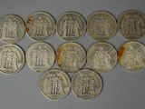 six different types of silver coins on a white surface