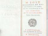 an open book with a picture of a wreath on it