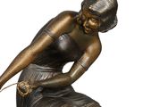 bronze statue of a woman sitting on a rock with a rope around her neck