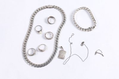 a lot of silver jewelry on a white surface