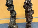 two bronze statues of a woman and a man on a pedestal